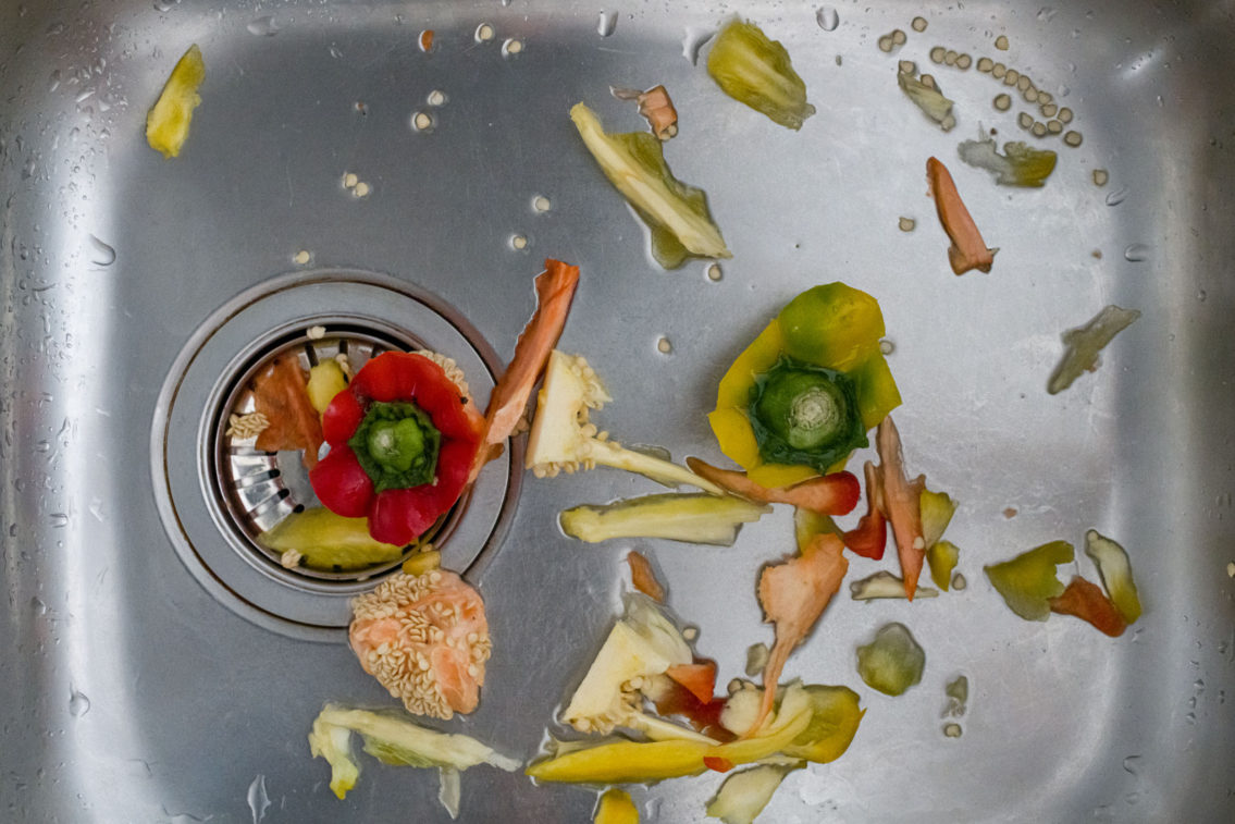 printed photograph of the remains of peppers in a steel sink